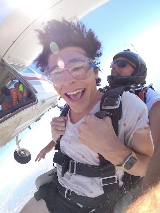 Tandem skydiving near Santa Cruz with plane in the background.