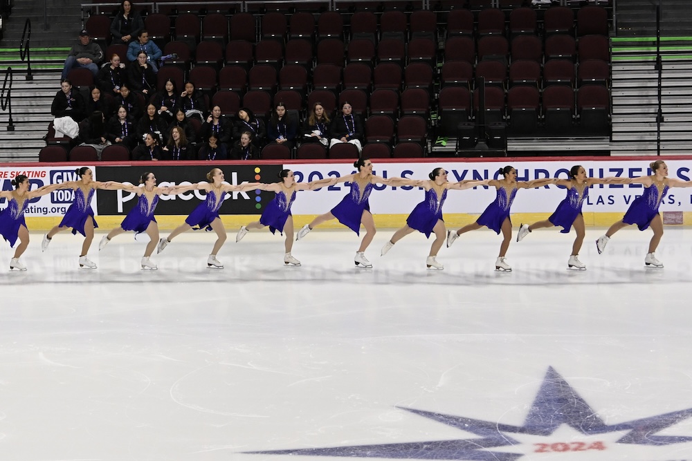 Brooke with her team as they skate in a single line.